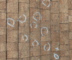 Roof with hail welts circled in chalk